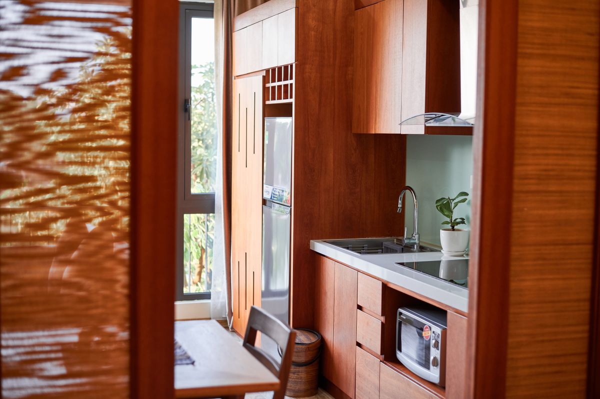 Warm timber kitchen cabinetry in natural summer light